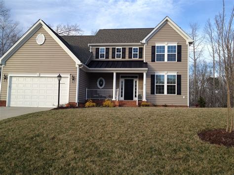 black metal roof tan house|tan siding with black shutters.